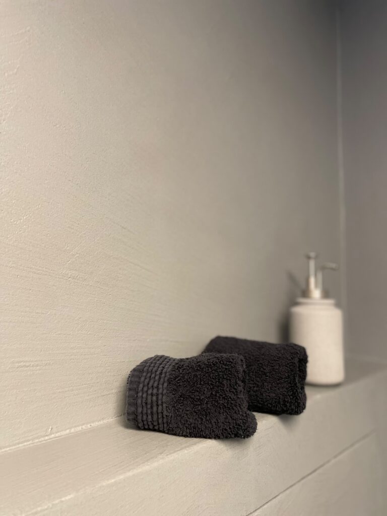 Modernes Badezimmer mit Waschtisch und fugenlosen grauen Wandoberflächen
